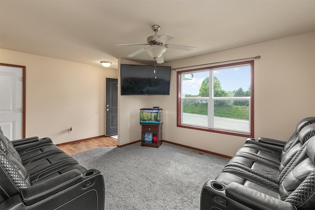 5301 SE 27th St, Des Moines, IA 50320 - living area featuring a ceiling fan, baseboards, and light carpet