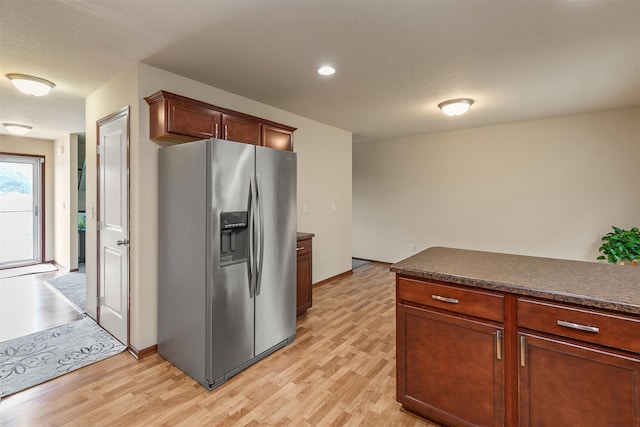 5301 SE 27th St, Des Moines, IA 50320 - kitchen featuring stainless steel fridge, light wood-style flooring, dark countertops, and recessed lighting