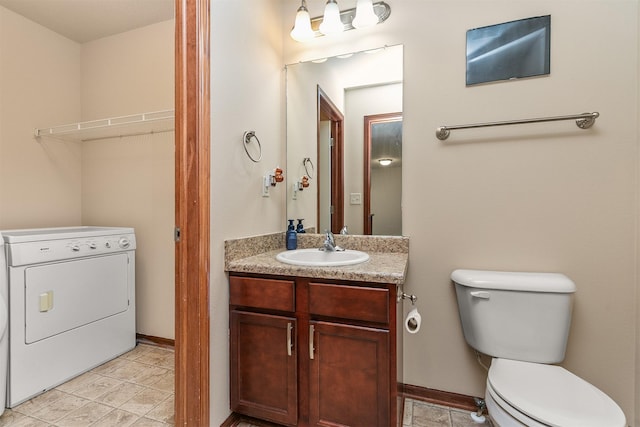 5301 SE 27th St, Des Moines, IA 50320 - bathroom featuring washer / clothes dryer, toilet, vanity, and baseboards