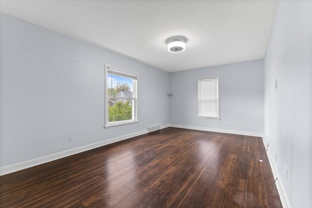 525 SW Walnut St, Ankeny, IA 50023 - empty room with baseboards, dark wood finished floors, and visible vents