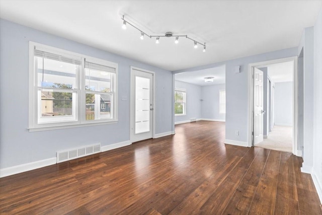 525 SW Walnut St, Ankeny, IA 50023 - unfurnished living room with rail lighting, wood-type flooring, baseboards, and visible vents