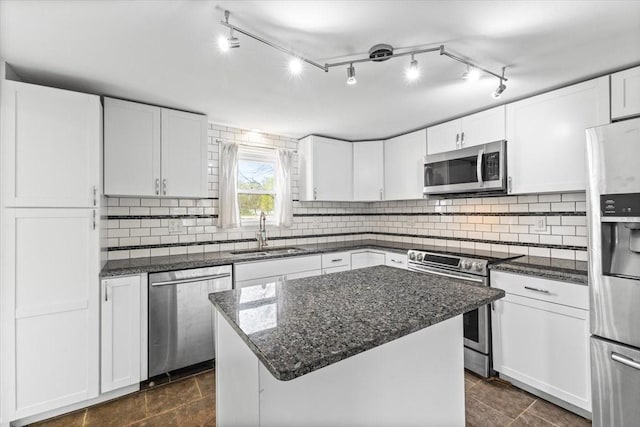 525 SW Walnut St, Ankeny, IA 50023 - kitchen with white cabinets, backsplash, appliances with stainless steel finishes, and a sink