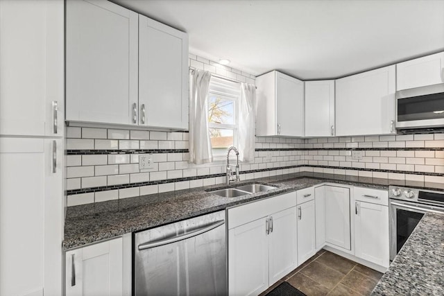 525 SW Walnut St, Ankeny, IA 50023 - kitchen featuring white cabinets, backsplash, stainless steel appliances, and a sink