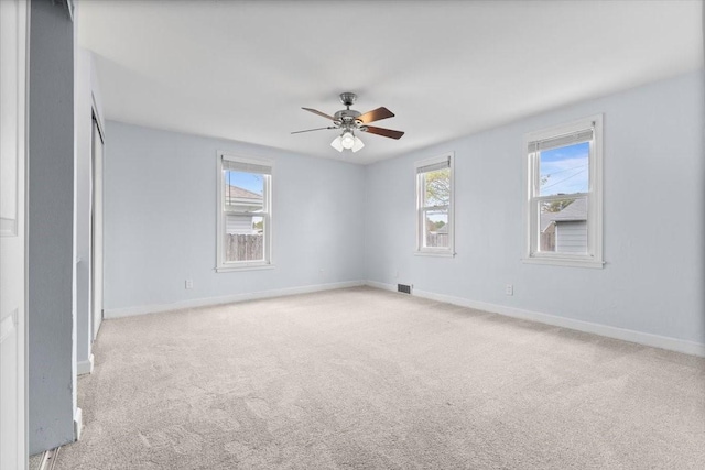 525 SW Walnut St, Ankeny, IA 50023 - empty room with light colored carpet, baseboards, a ceiling fan, and visible vents