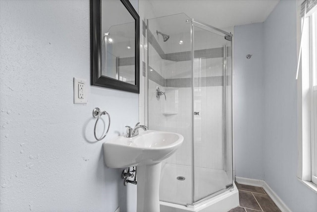525 SW Walnut St, Ankeny, IA 50023 - bathroom with a stall shower, tile patterned flooring, and baseboards