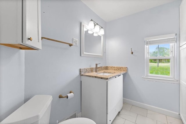 525 SW Walnut St, Ankeny, IA 50023 - bathroom with vanity, toilet, baseboards, and marble finish floor