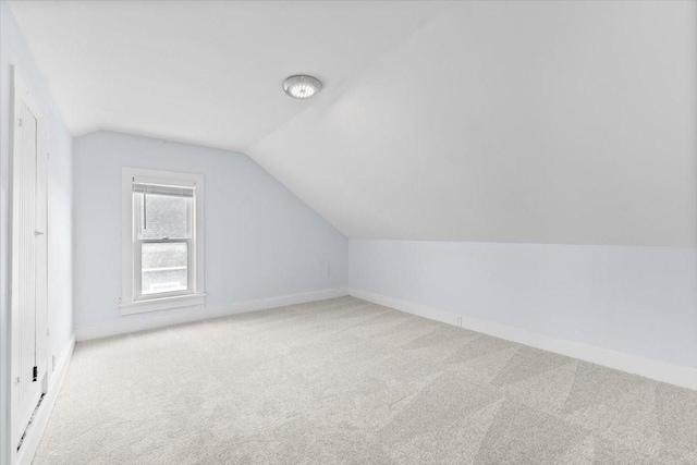525 SW Walnut St, Ankeny, IA 50023 - additional living space featuring baseboards, carpet floors, and vaulted ceiling