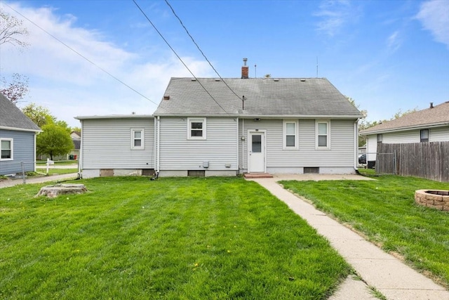 525 SW Walnut St, Ankeny, IA 50023 - rear view of property featuring an outdoor fire pit, a yard, a chimney, and fence