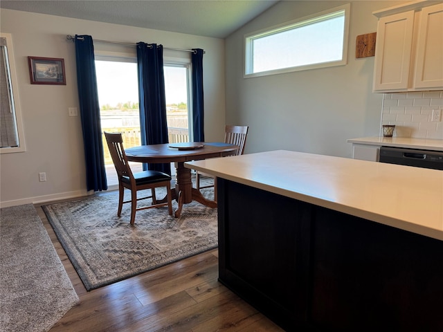 2708 NW Boulder Point Pl, Ankeny, IA 50023 - dining area with baseboards, wood finished floors, and lofted ceiling