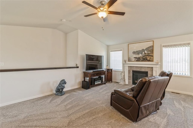 2708 NW Boulder Point Pl, Ankeny, IA 50023 - carpeted living room with vaulted ceiling, a tiled fireplace, baseboards, and ceiling fan