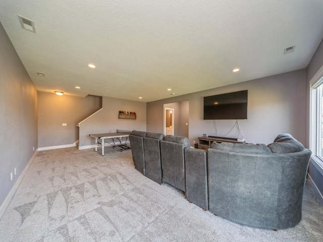 carpeted living room with baseboards, visible vents, and recessed lighting