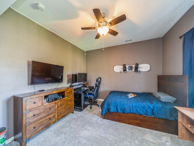 carpeted bedroom with baseboards, a ceiling fan, and visible vents