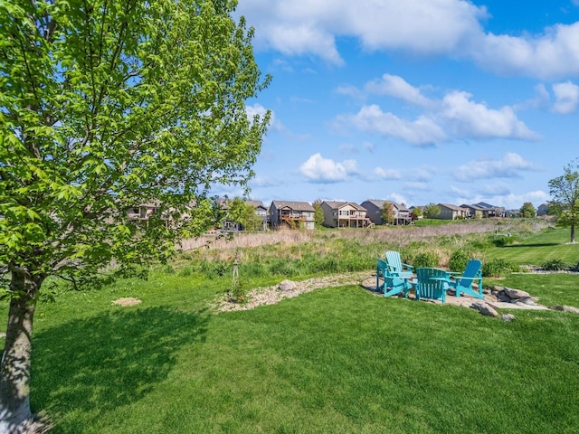 view of yard with a residential view and a fire pit