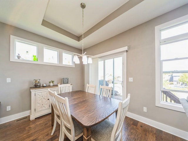 dining area with a chandelier, dark wood finished floors, plenty of natural light, and baseboards