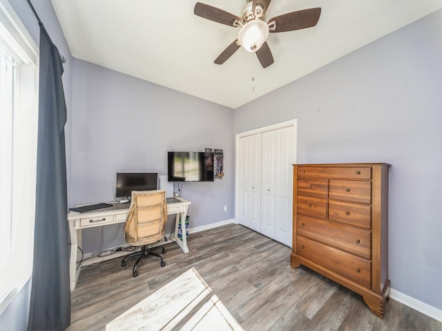 office featuring baseboards, lofted ceiling, a ceiling fan, and wood finished floors