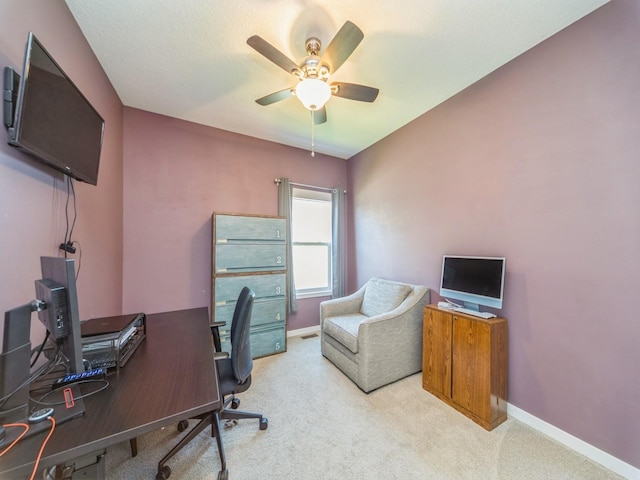 office area featuring a ceiling fan, carpet flooring, and baseboards