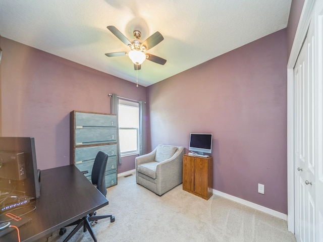 office area with a ceiling fan, baseboards, and carpet floors