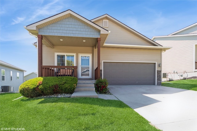 4522 145th St, Urbandale, IA 50323 - view of front of home featuring covered porch, central AC, concrete driveway, a garage, and a front yard