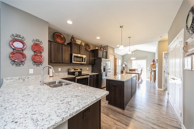 4522 145th St, Urbandale, IA 50323 - kitchen featuring a sink, stainless steel appliances, light wood-type flooring, dark brown cabinetry, and a center island