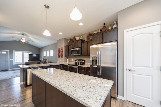 4522 145th St, Urbandale, IA 50323 - kitchen featuring appliances with stainless steel finishes, a center island, dark brown cabinets, a peninsula, and light wood-type flooring