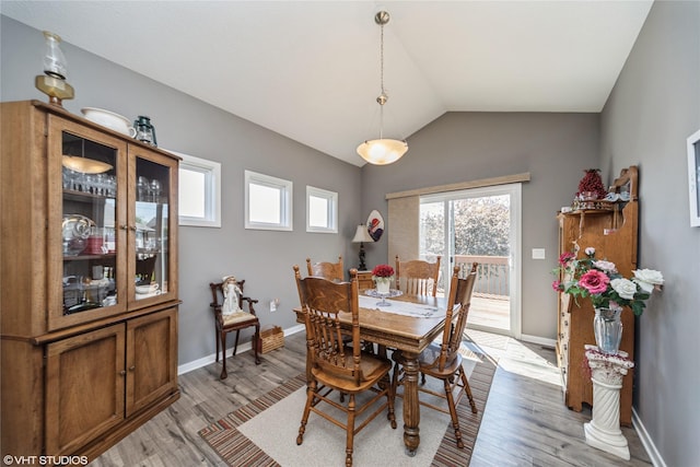 4522 145th St, Urbandale, IA 50323 - dining space with vaulted ceiling, light wood-style flooring, and baseboards