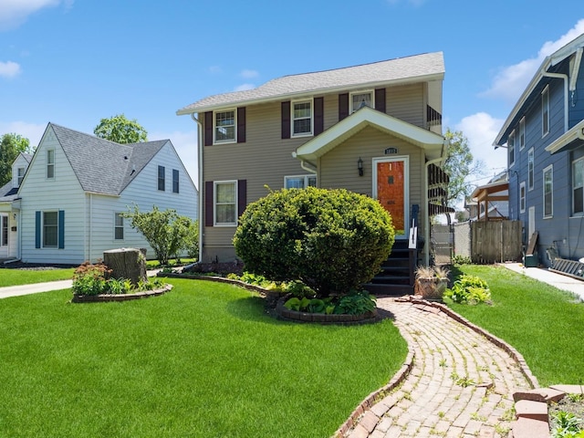 view of front of house with a front lawn and fence