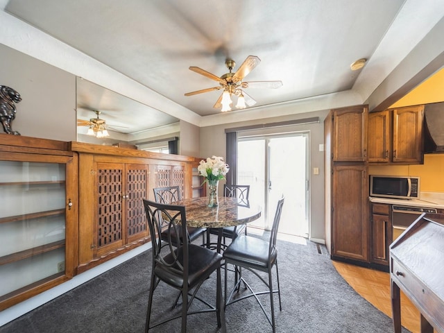 dining space featuring baseboards and ceiling fan
