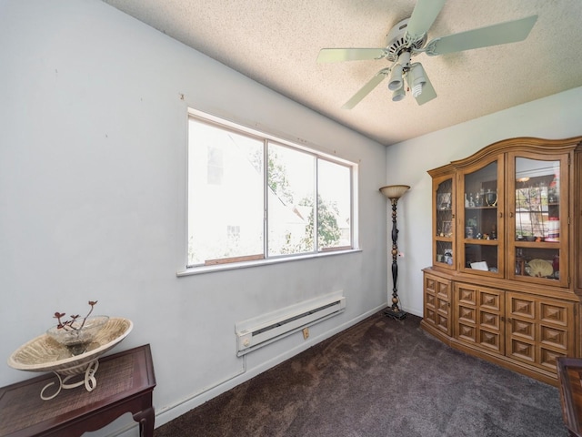 empty room featuring carpet floors, baseboard heating, ceiling fan, and a textured ceiling