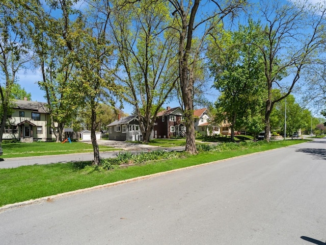 view of road featuring a residential view and curbs
