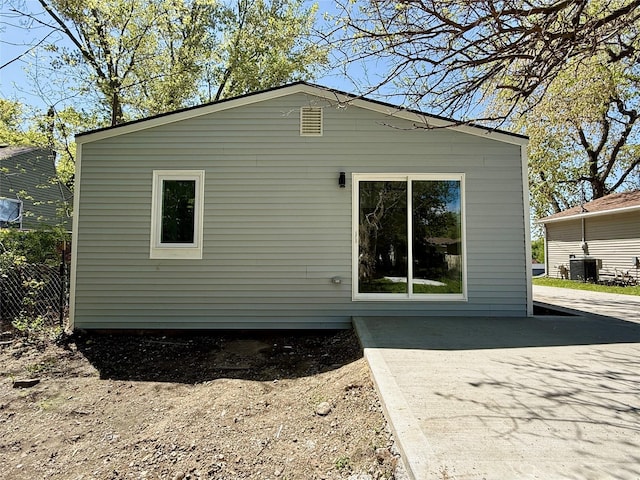 rear view of house featuring central AC