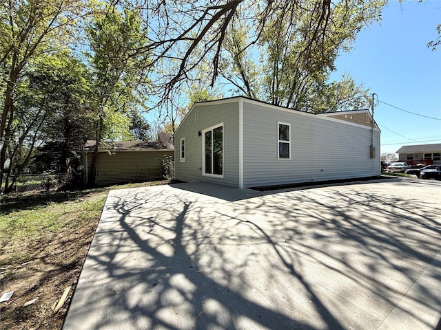 rear view of property featuring fence