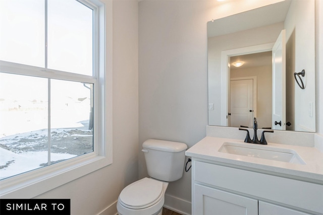 4112 NE 5th St, Ankeny, IA 50021 - bathroom featuring toilet, baseboards, and vanity