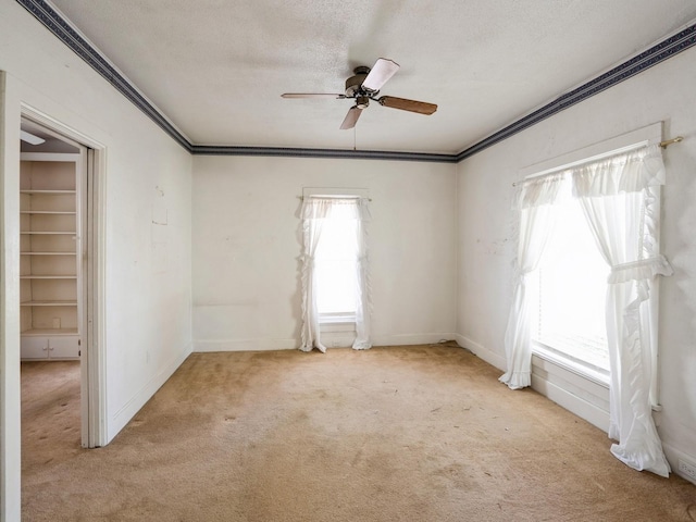 325 W 8th St S, Newton, IA 50208 - carpeted empty room featuring a ceiling fan, ornamental molding, baseboards, and a textured ceiling