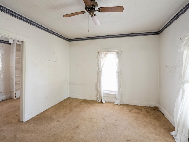 325 W 8th St S, Newton, IA 50208 - unfurnished bedroom featuring light carpet, ornamental molding, baseboards, and a ceiling fan