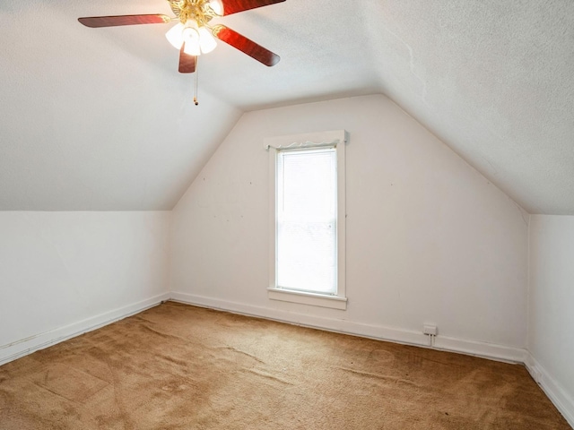 325 W 8th St S, Newton, IA 50208 - bonus room with carpet floors, vaulted ceiling, a ceiling fan, baseboards, and a textured ceiling