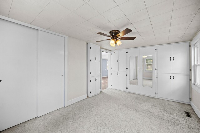 905 E 8th St S, Newton, IA 50208 - unfurnished bedroom with baseboards and ceiling fan