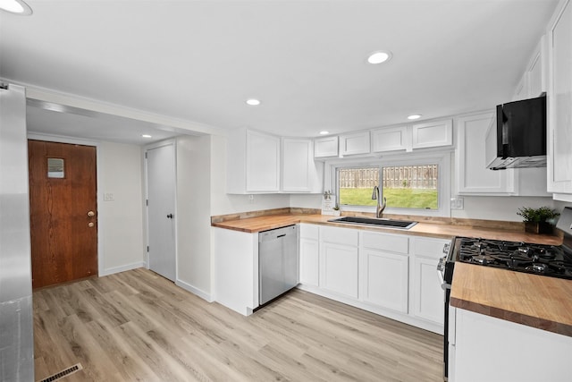 905 E 8th St S, Newton, IA 50208 - kitchen with wooden counters, gas stove, a sink, dishwasher, and black microwave