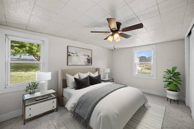 905 E 8th St S, Newton, IA 50208 - bedroom featuring baseboards, ceiling fan, and light carpet