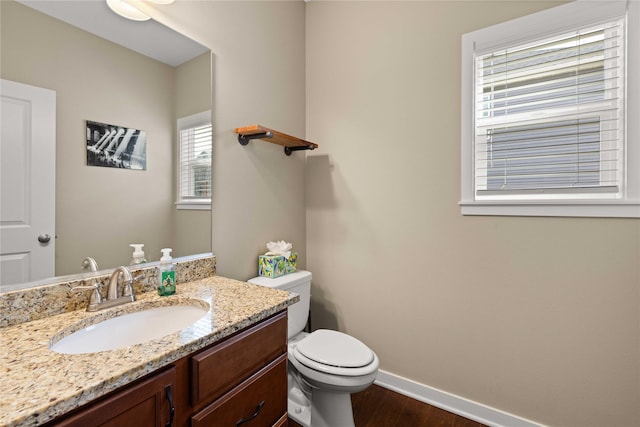 270 NE Prairie Wolf Dr, Waukee, IA 50263 - half bath featuring baseboards, wood finished floors, toilet, and vanity
