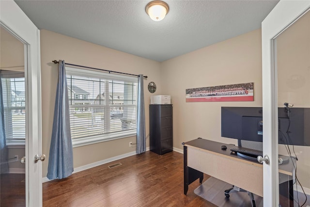 270 NE Prairie Wolf Dr, Waukee, IA 50263 - office space featuring dark wood-style floors, baseboards, a textured ceiling, and french doors