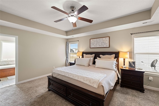 270 NE Prairie Wolf Dr, Waukee, IA 50263 - carpeted bedroom with baseboards, ensuite bath, and a ceiling fan