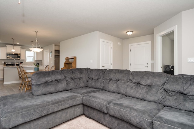 living area featuring light wood-type flooring and recessed lighting