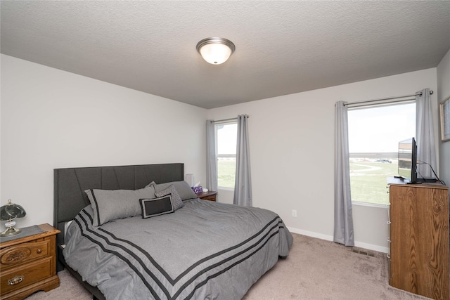 bedroom featuring baseboards and light colored carpet