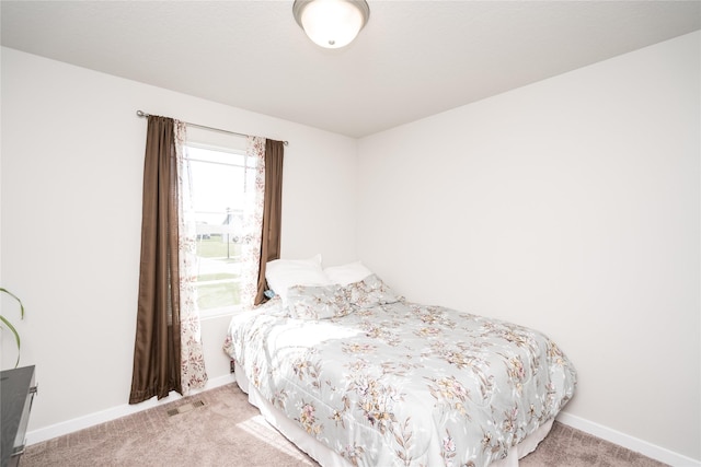 bedroom with carpet flooring, baseboards, and visible vents
