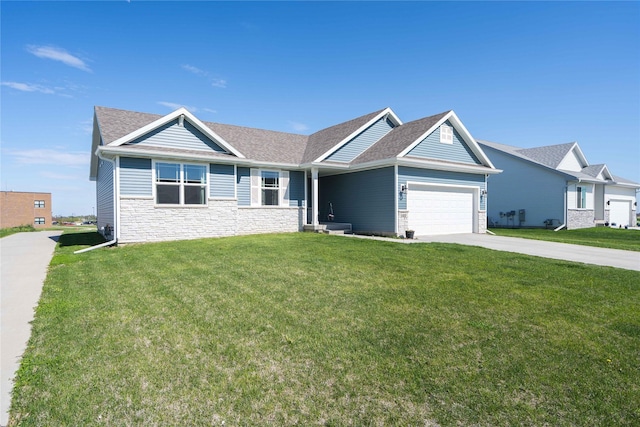 view of front of home featuring an attached garage, a front yard, and stone siding