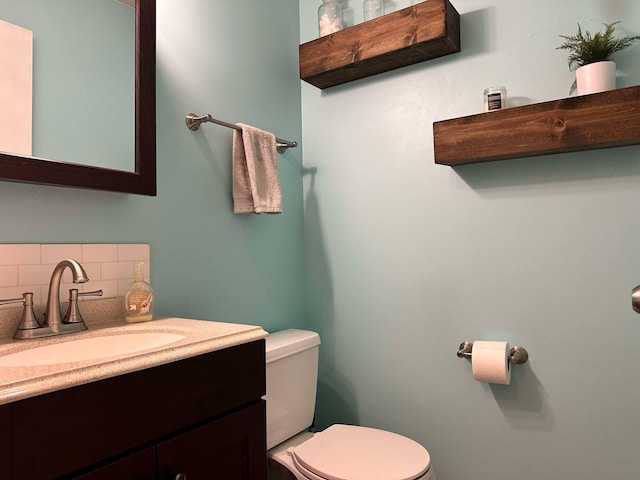 917 SE Allyn St, Ankeny, IA 50021 - bathroom with vanity, toilet, and decorative backsplash