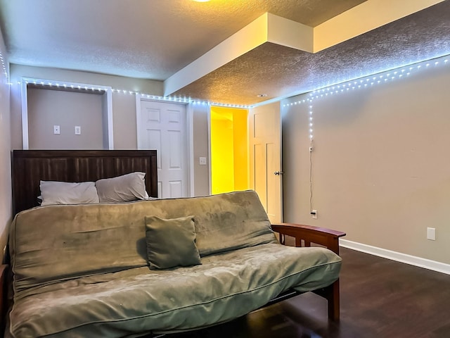 917 SE Allyn St, Ankeny, IA 50021 - bedroom with a textured ceiling, wood finished floors, and baseboards