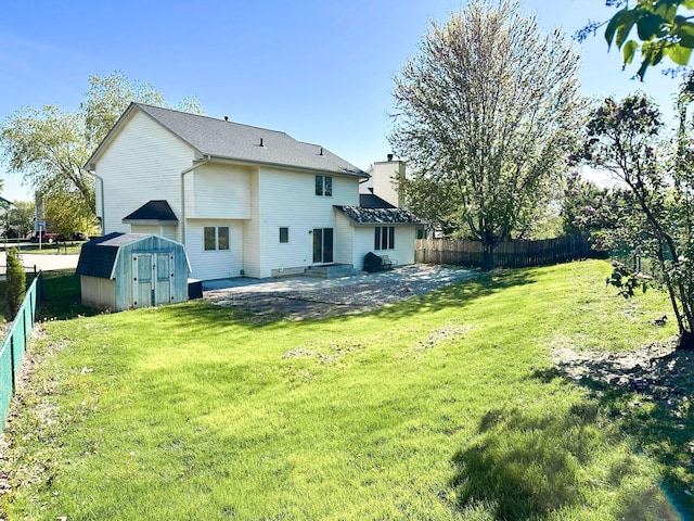 917 SE Allyn St, Ankeny, IA 50021 - back of house featuring a yard, a patio, a fenced backyard, and a storage unit