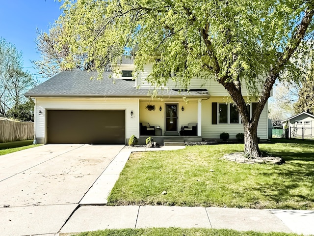 917 SE Allyn St, Ankeny, IA 50021 - view of front of house with a front yard, driveway, an attached garage, and fence