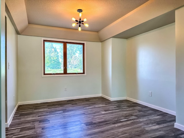 917 SE Allyn St, Ankeny, IA 50021 - spare room with a textured ceiling, a chandelier, and dark wood-style floors